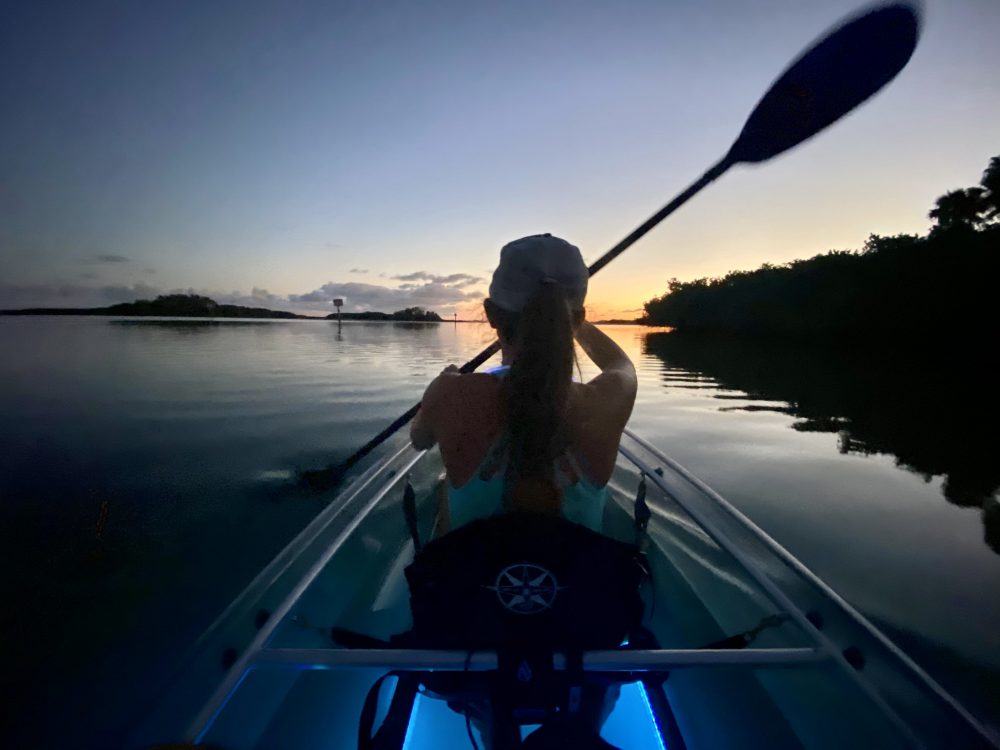 a person sitting next to a body of water