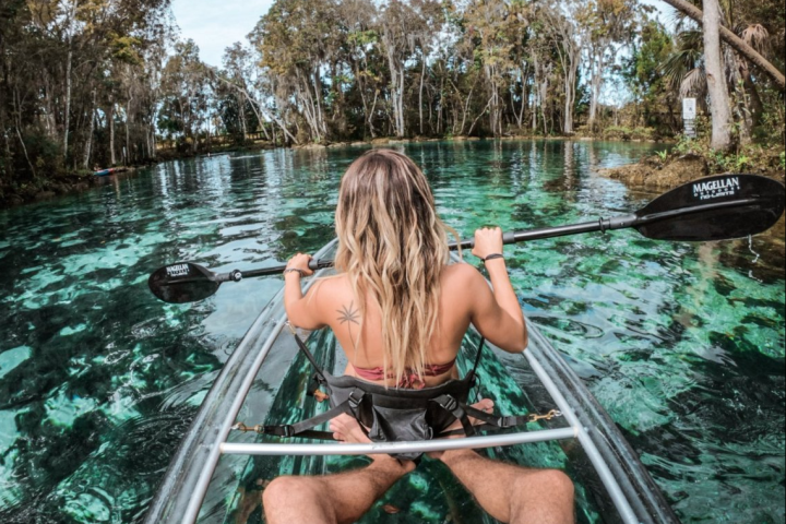 a person sitting on a boat in a body of water