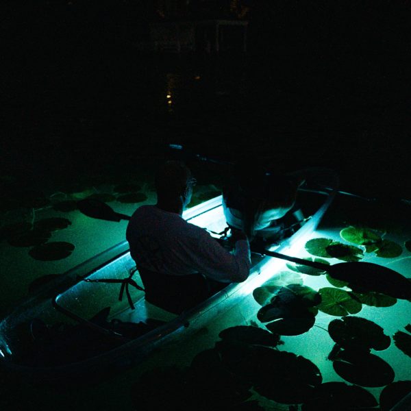 a screen shot of a man in a dark room