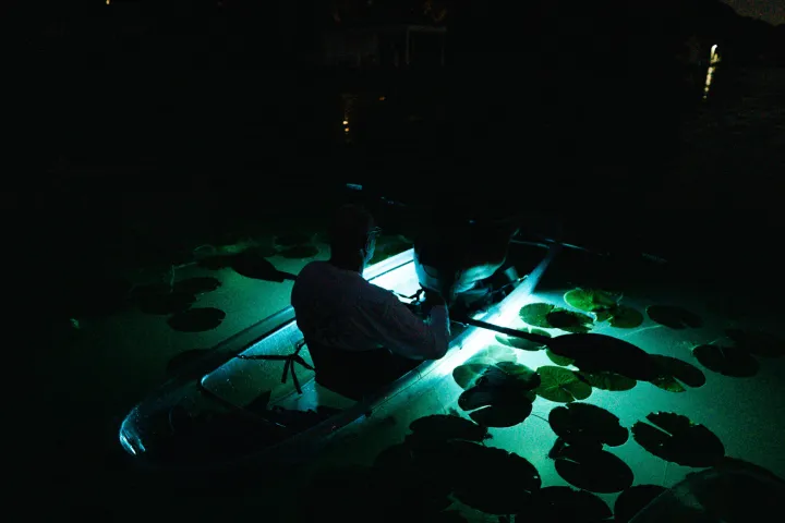a screen shot of a man in a dark room