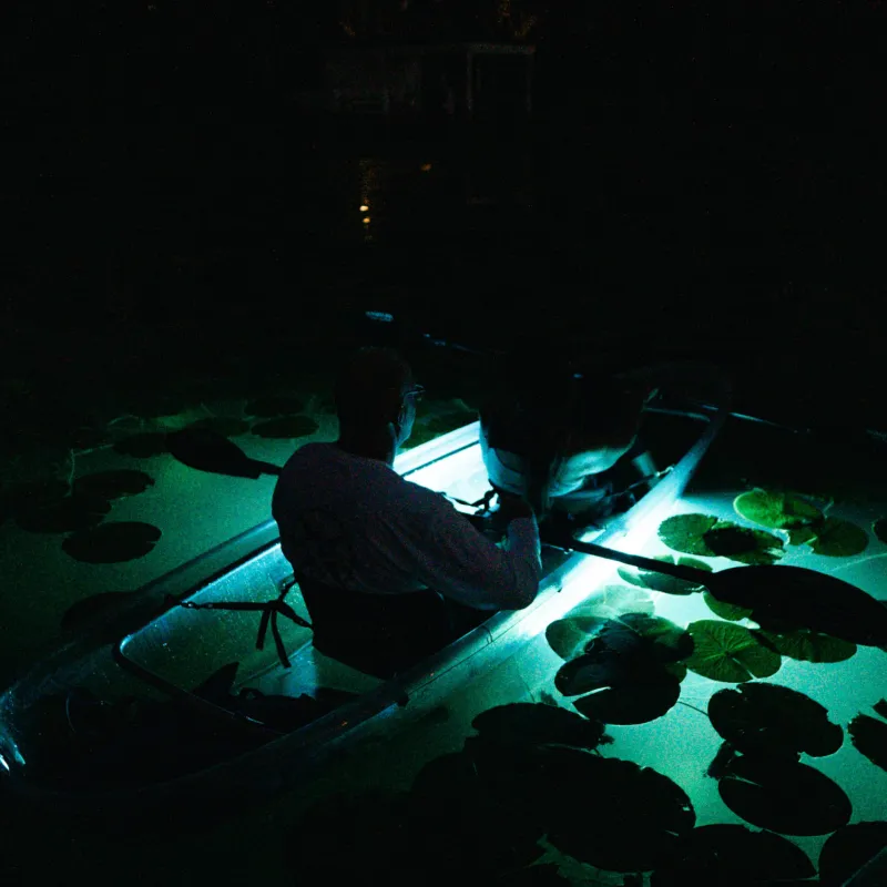 a screen shot of a man in a dark room