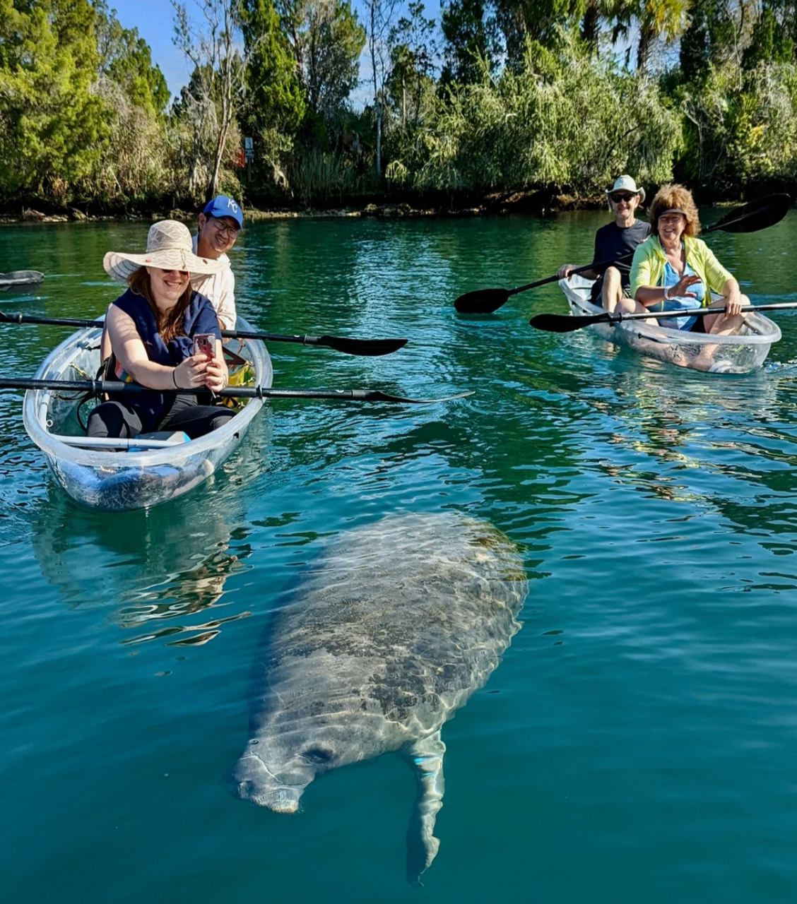 image a group of people riding on the back of a boat in the water