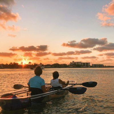 a group of people in a boat on a body of water