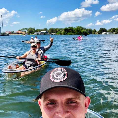 a man with a hat on a boat in the water