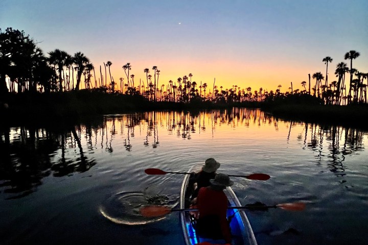 a person standing next to a body of water