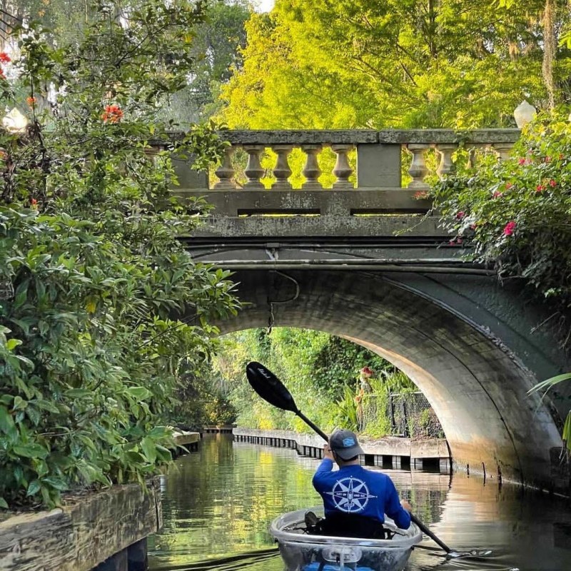 a boat traveling across a bridge over a body of water