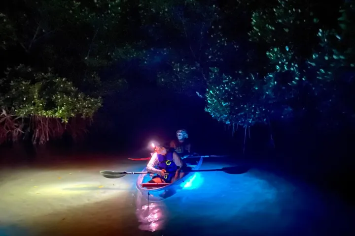 a person riding a motorcycle in the water