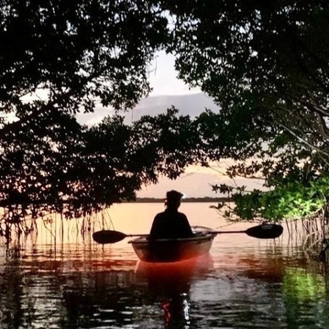 a person standing next to a body of water