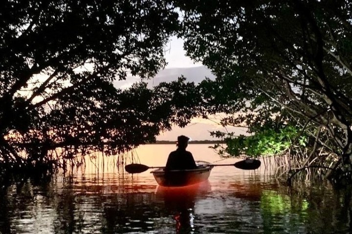 a person standing next to a body of water