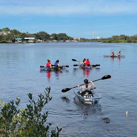 a group of people in a boat on a body of water