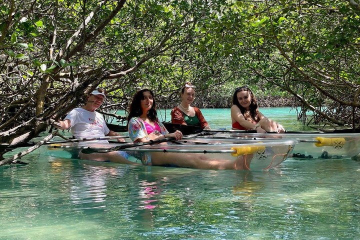 a group of people rowing a boat in the water