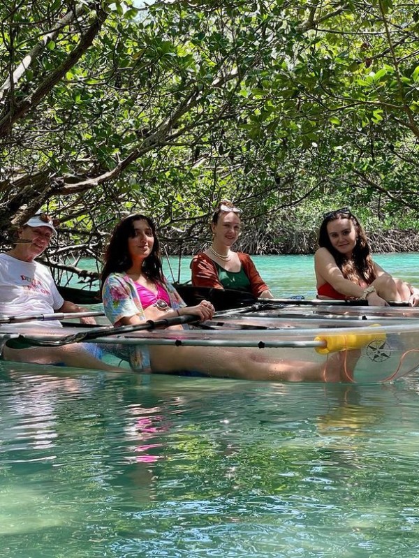 a group of people rowing a boat in the water