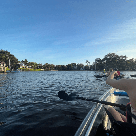 a man sitting in a boat on a body of water
