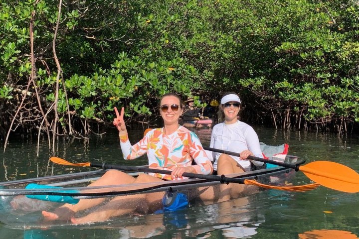a group of people rowing a boat in the water