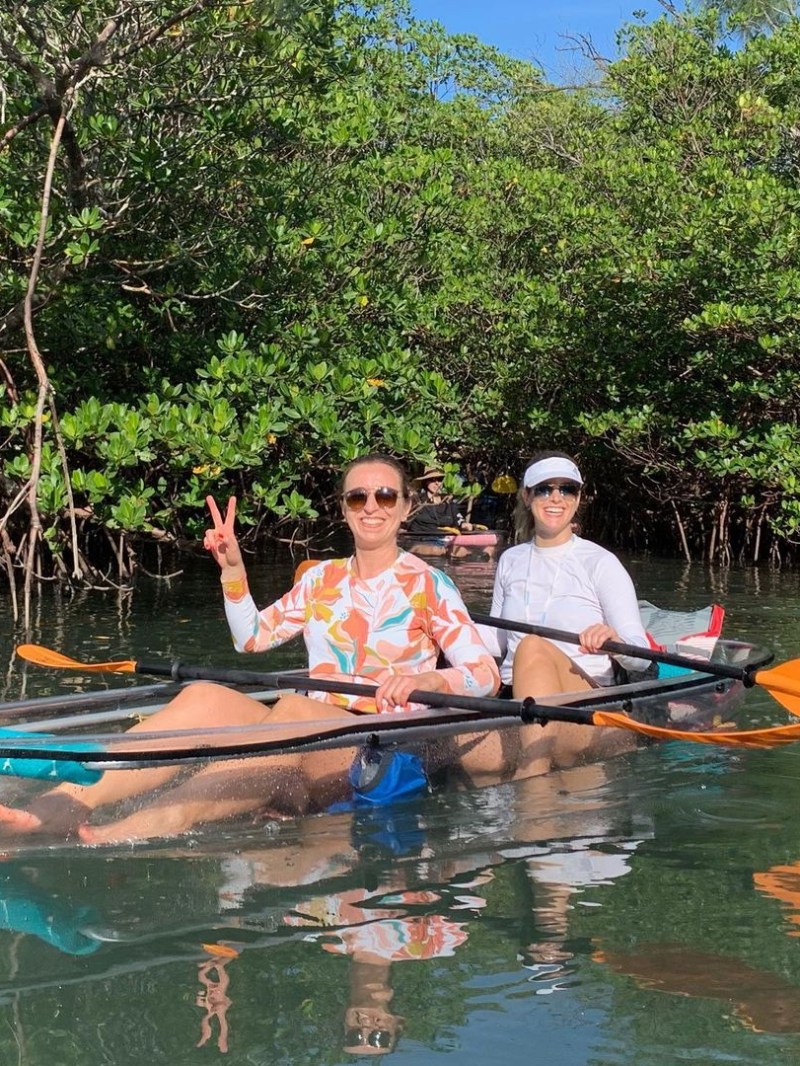 a group of people rowing a boat in the water