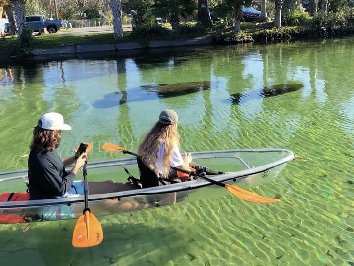 a group of people rowing a boat in the water