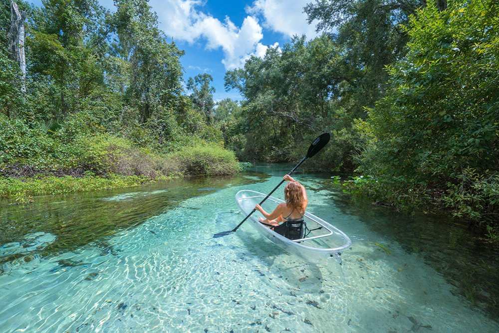a person riding on the back of a boat in the water