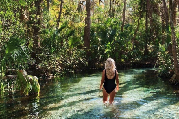 a person standing next to a body of water