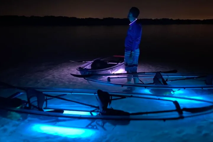 a man standing next to a body of water