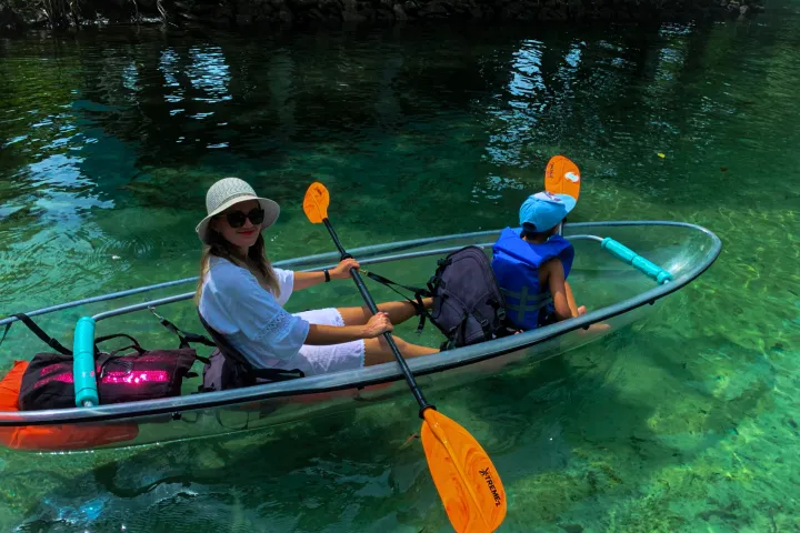 a group of people in a small boat in a body of water