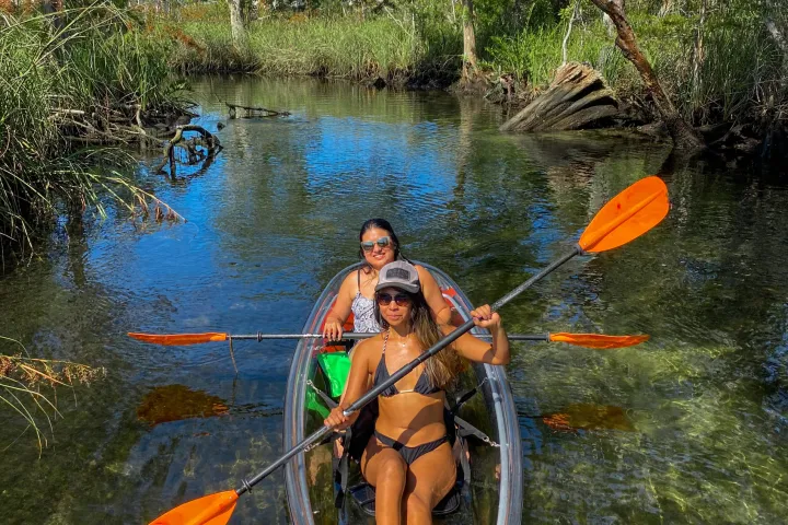 a man standing next to a body of water