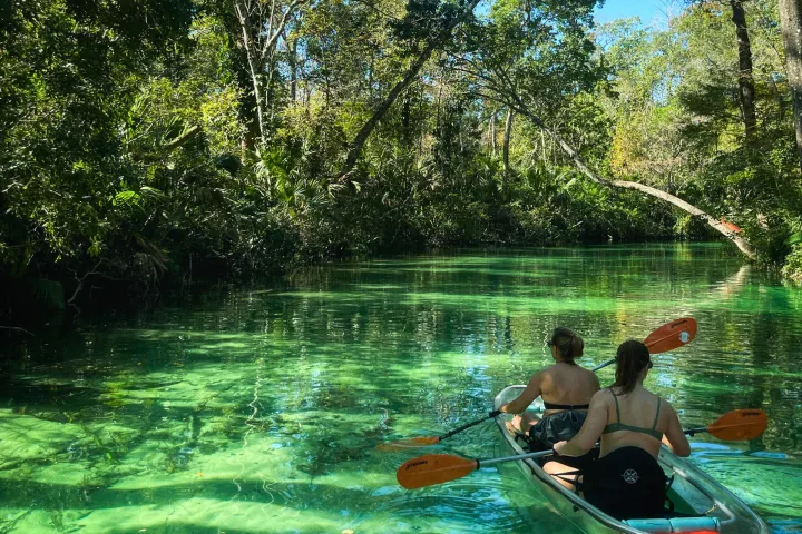 a man standing next to a body of water