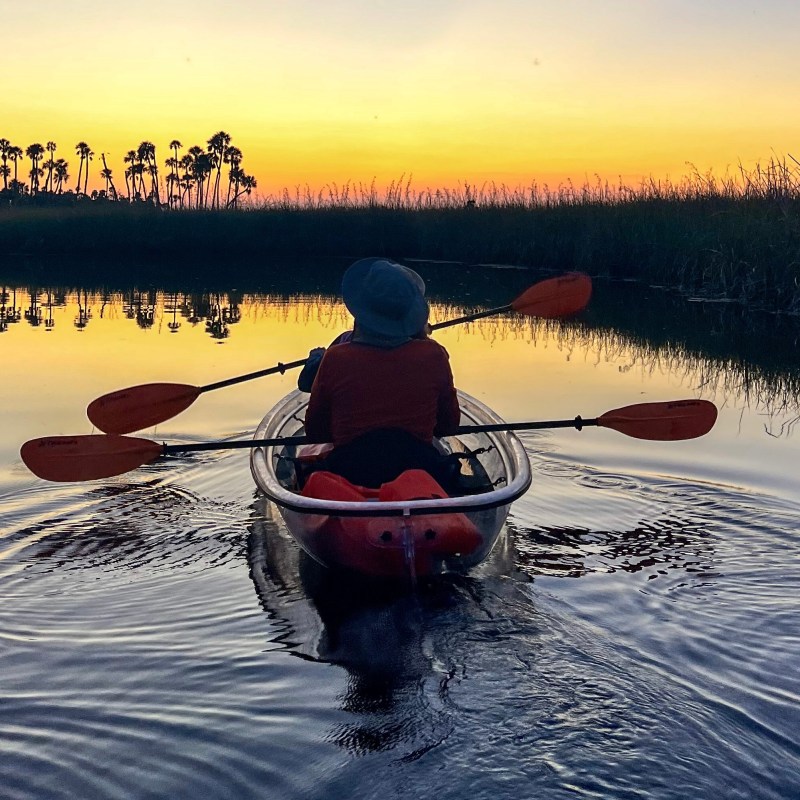 a person riding on the back of a boat in a body of water