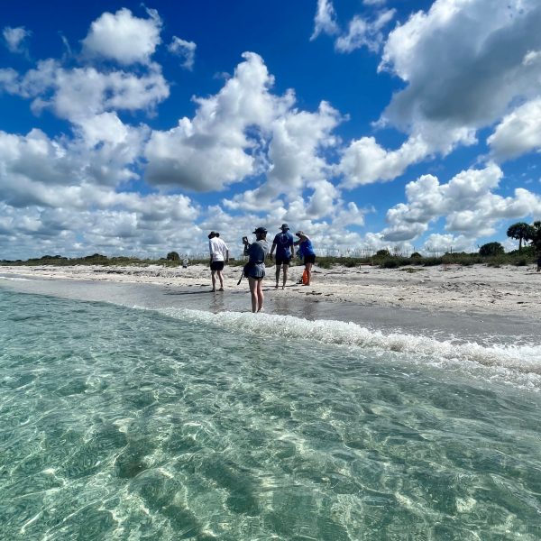 a man riding a wave on a cloudy day