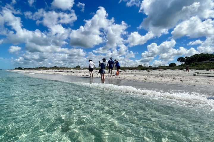 a man riding a wave on a cloudy day
