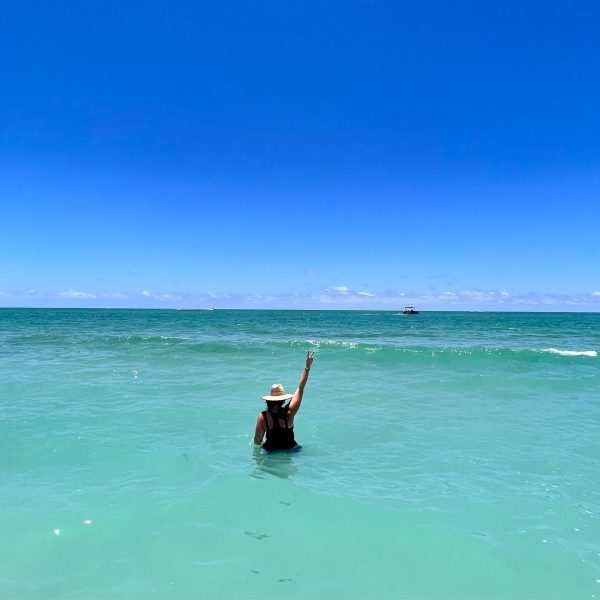 a man standing next to a body of water