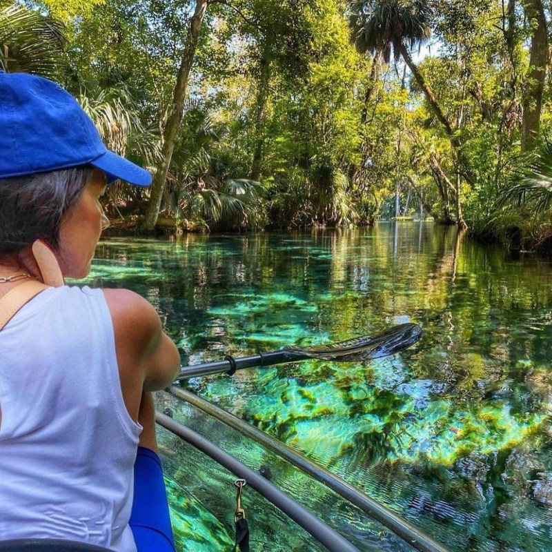 a person standing in front of a pond