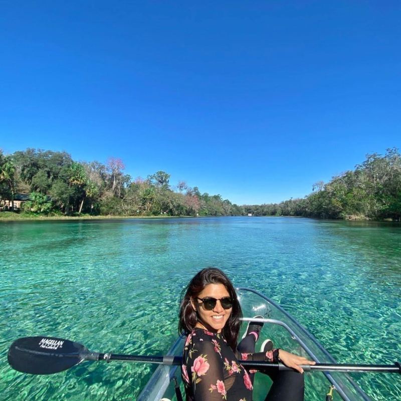 a person sitting on a dock next to a body of water