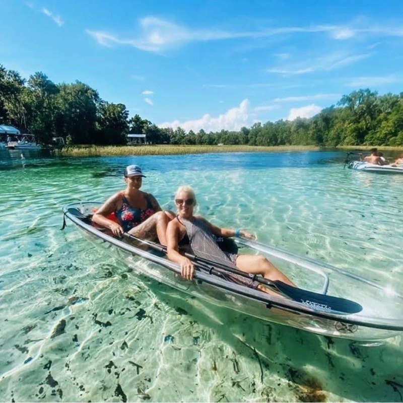 a person riding on the back of a boat in the water