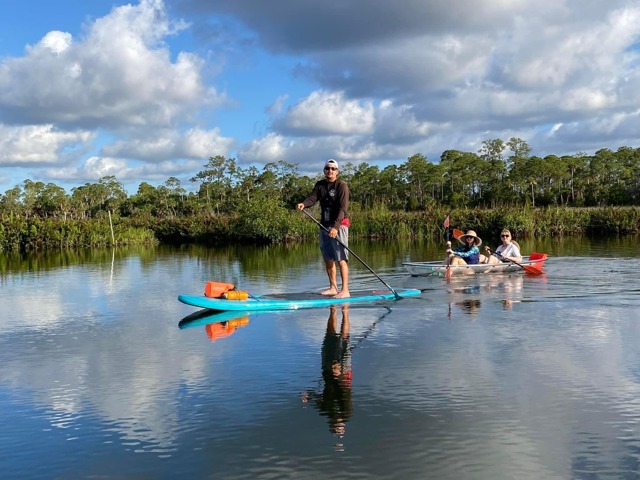 a group of people riding on the back of a boat in the water