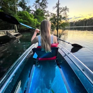 a person standing next to a body of water