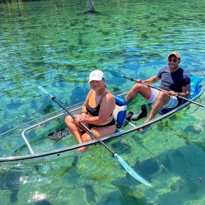 a group of people riding skis on a body of water