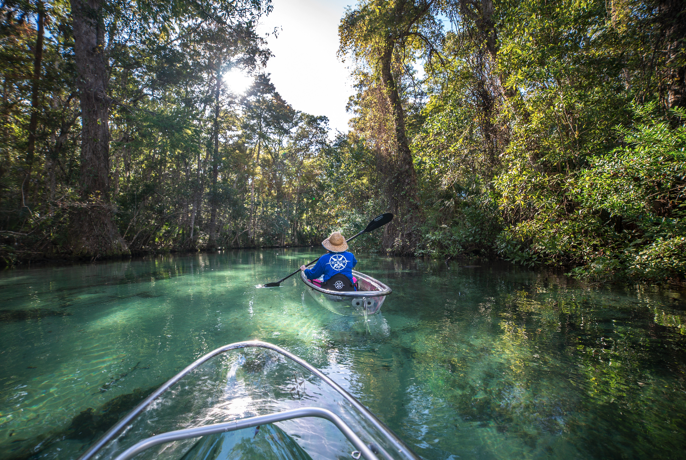 a man riding on the back of a boat in the water