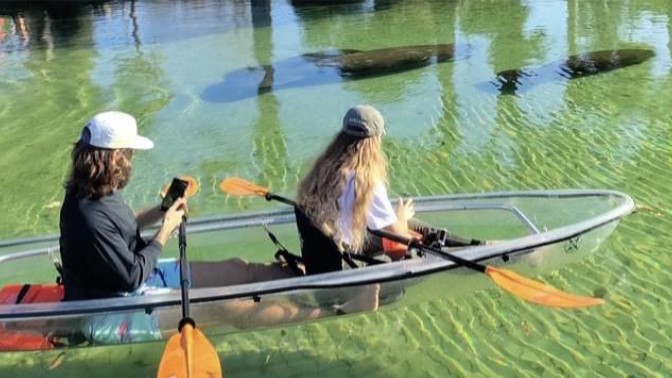 a group of people rowing a boat in the water