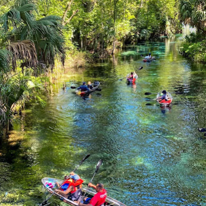 a group of people riding on the back of a boat on a river