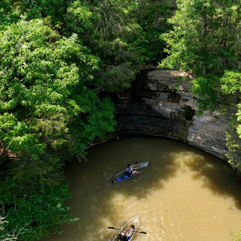 a person riding a motorcycle down a river