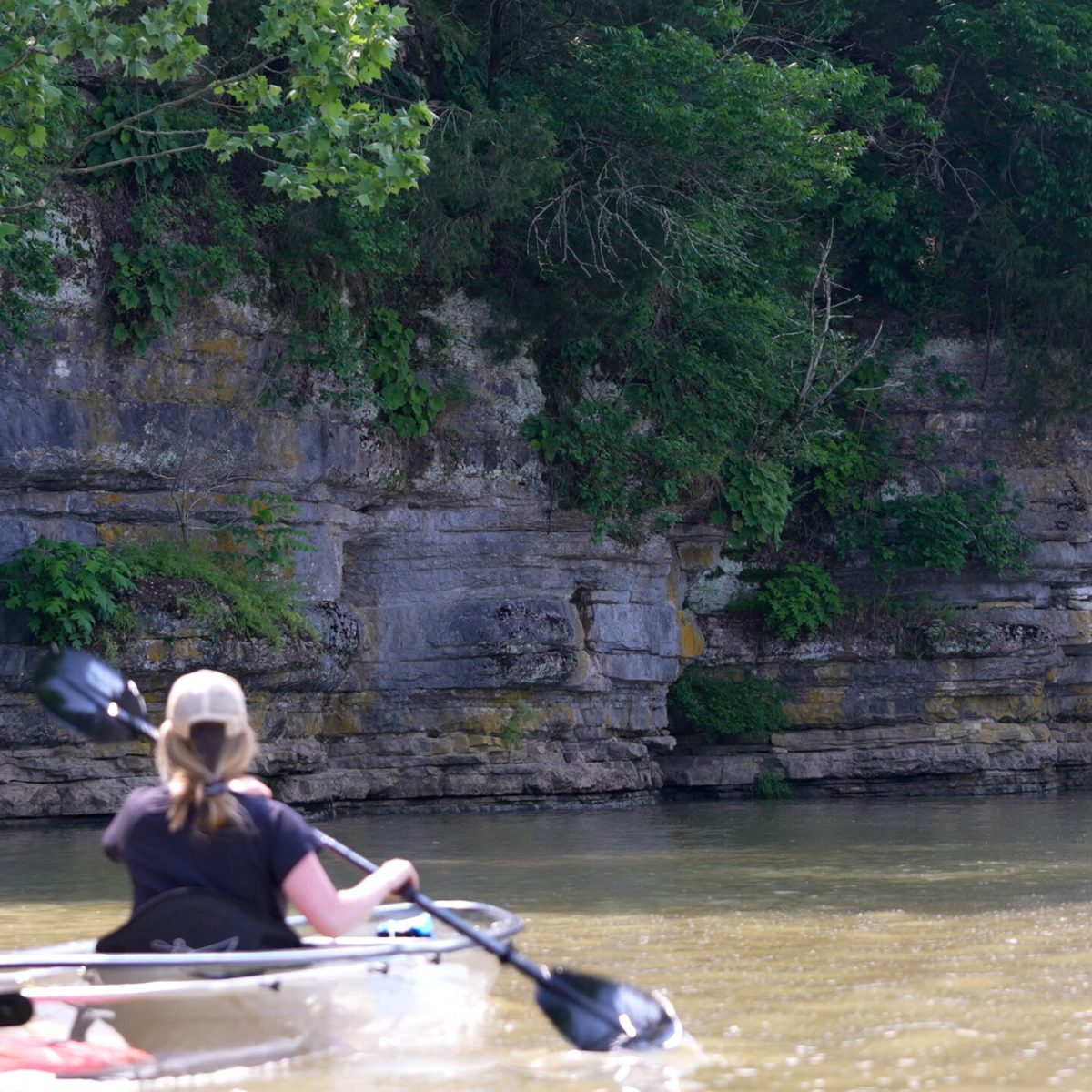a person riding on the back of a boat in the water