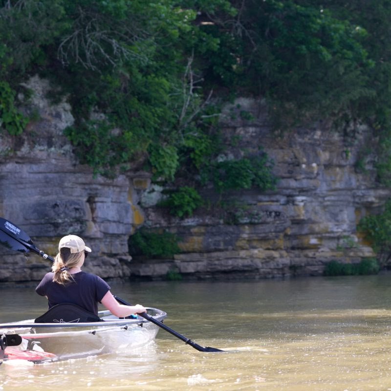 a man rowing a boat in a body of water