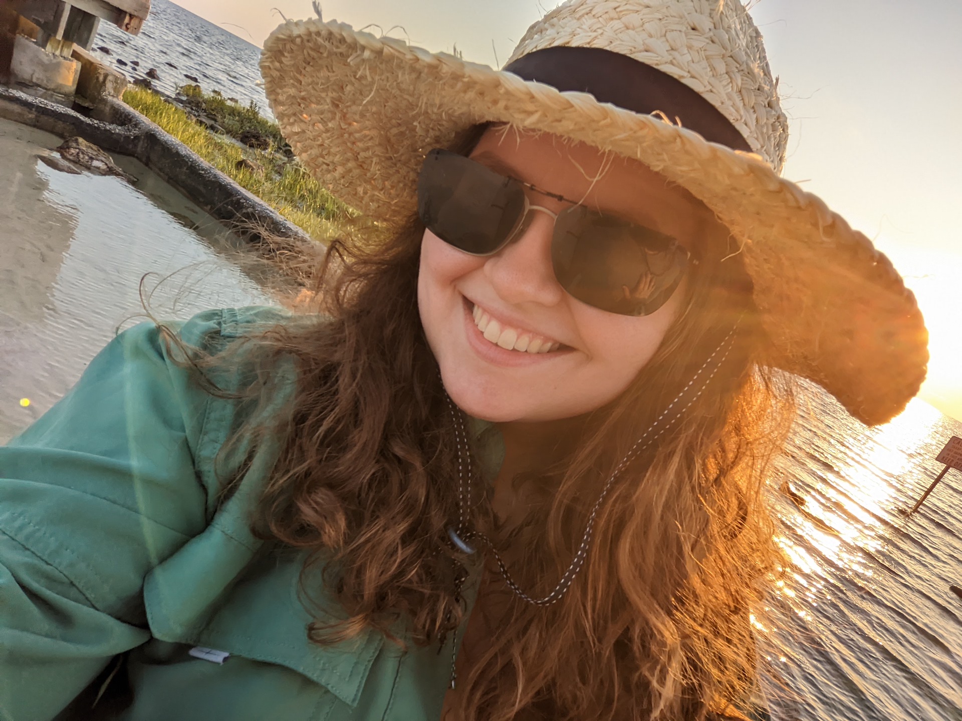 a woman wearing a hat and sunglasses