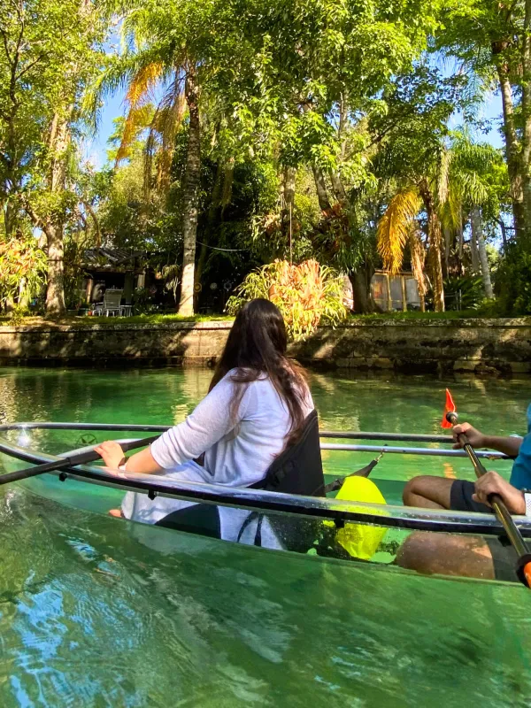 a group of people rowing a boat in the water
