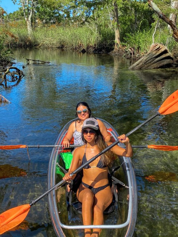 a man standing next to a body of water