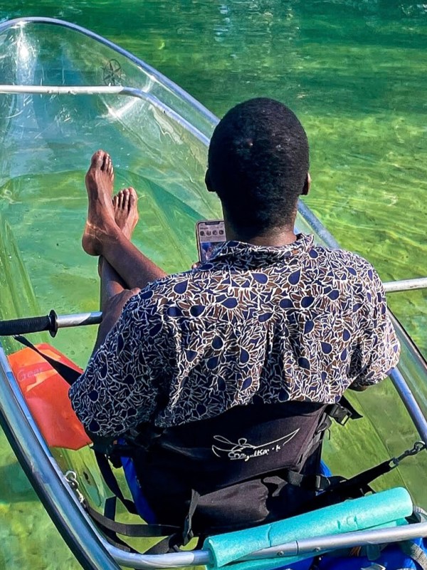 a person sitting next to a body of water