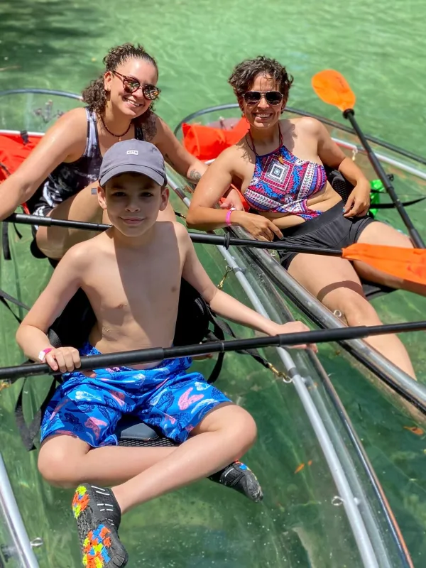 a group of people rowing a boat in the water