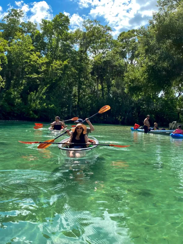 a group of people rowing a boat in the water