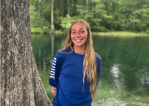 a person standing in front of a forest