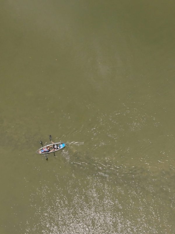 a person flying through the air over a body of water